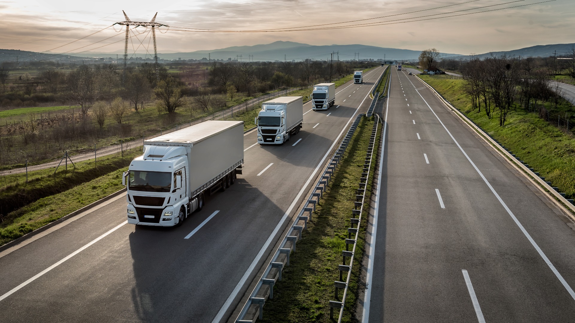 Caravan or convoy of trucks in line on a country highway